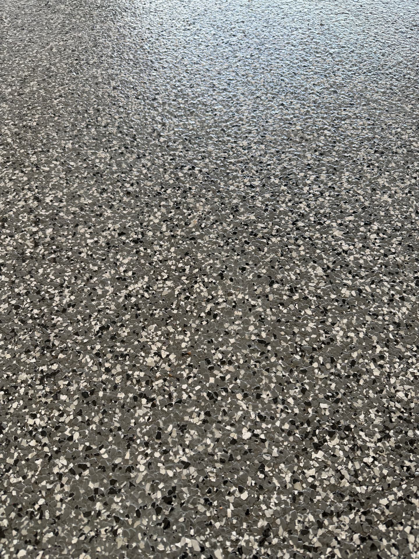 Close-up of grey, white and black epoxy flake finish